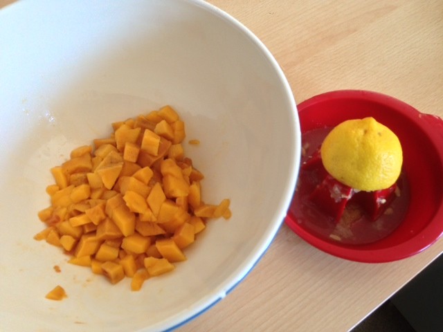 Eine Mango schälen und klein würfeln. 1/2 Zitrone ausdrücken.