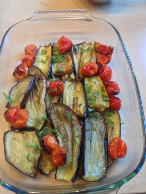 Baked eggplant with cocktail tomatoes, garnished with fresh coriander